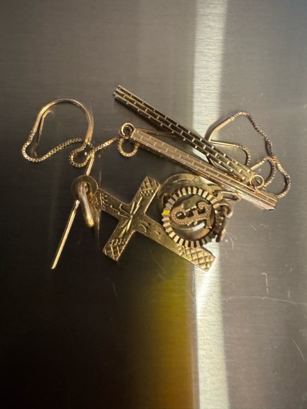 3 grams of 10 k gold! Misc. cross pendant, 2 small charms, dangle earrings!